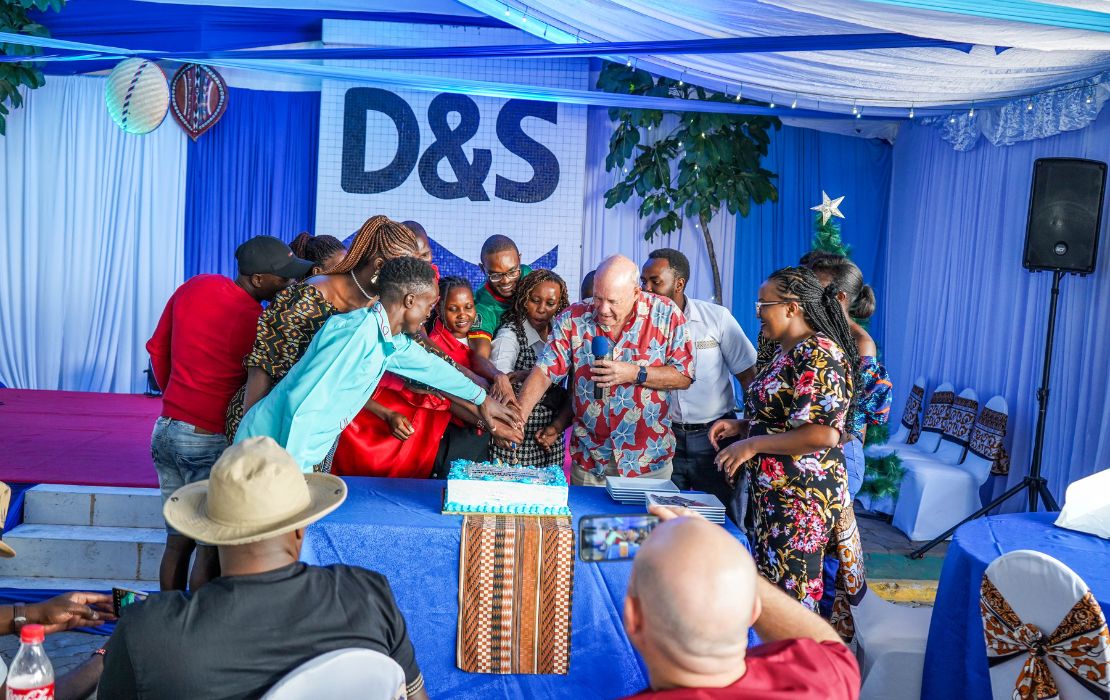 Davis & Shirtliff staff and the Group Chairman, cutting cake during christmas celebration